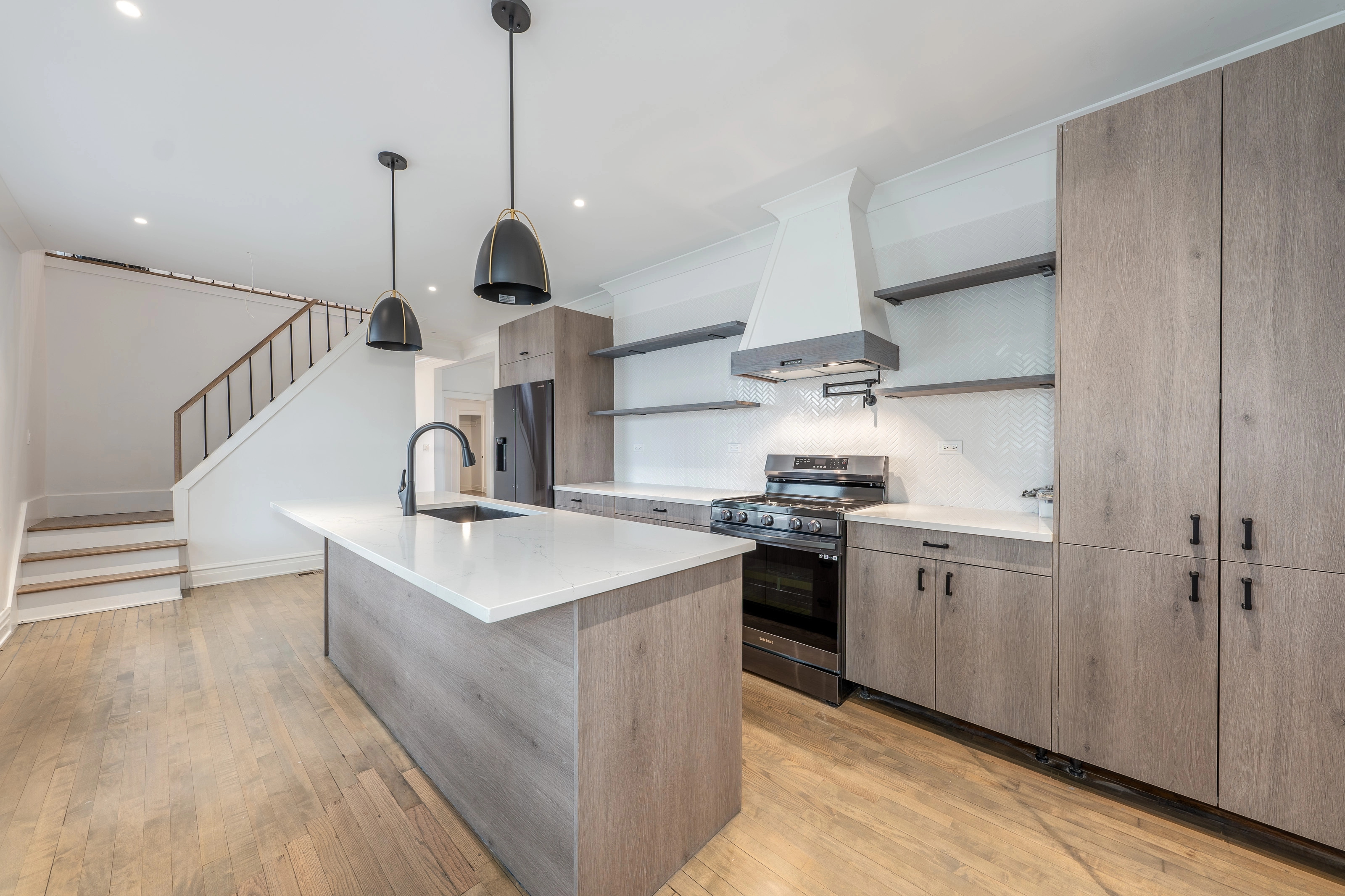 Kitchen with lights on range hood over stove