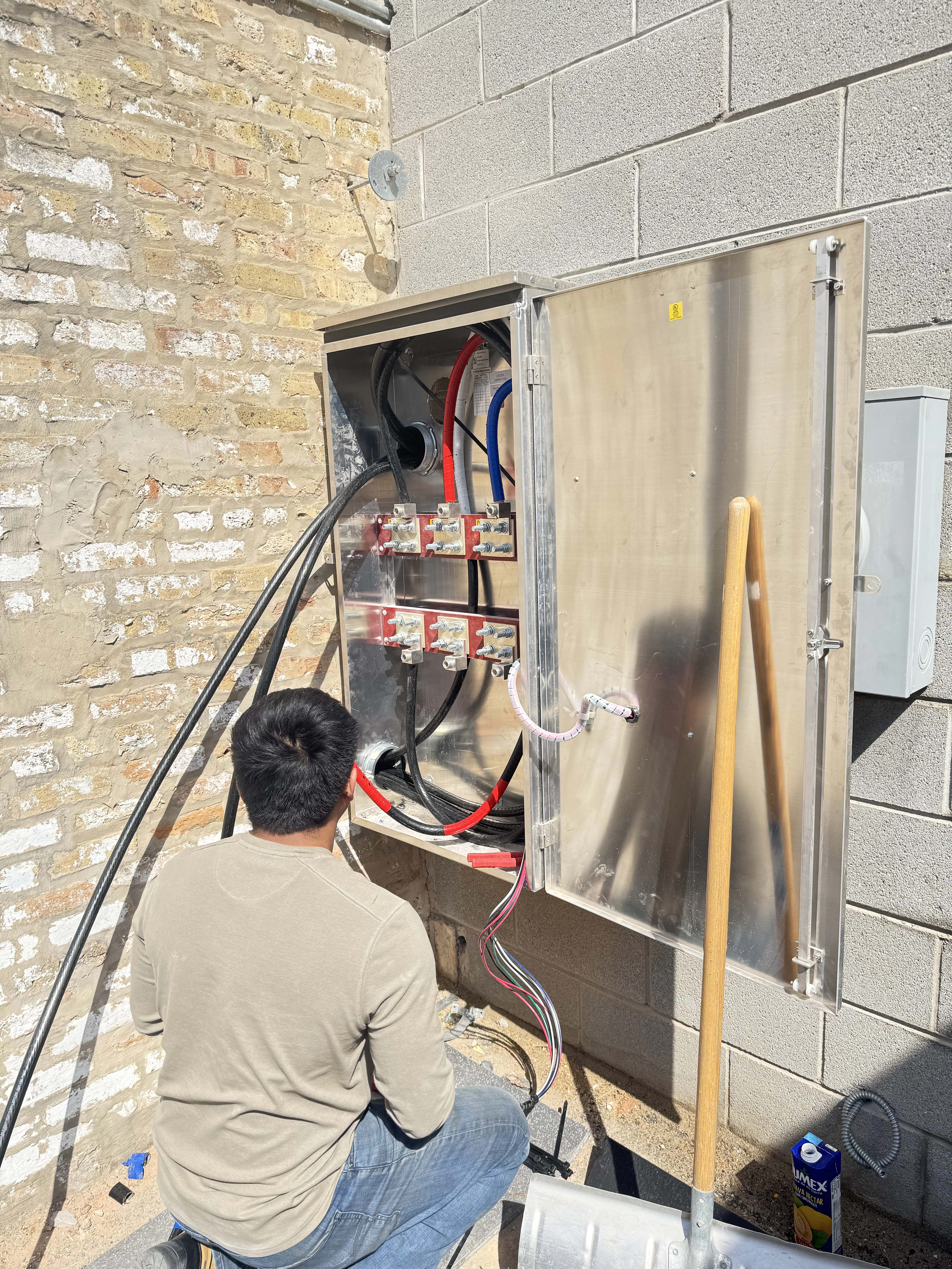 Electrician working on outdoor electrical box